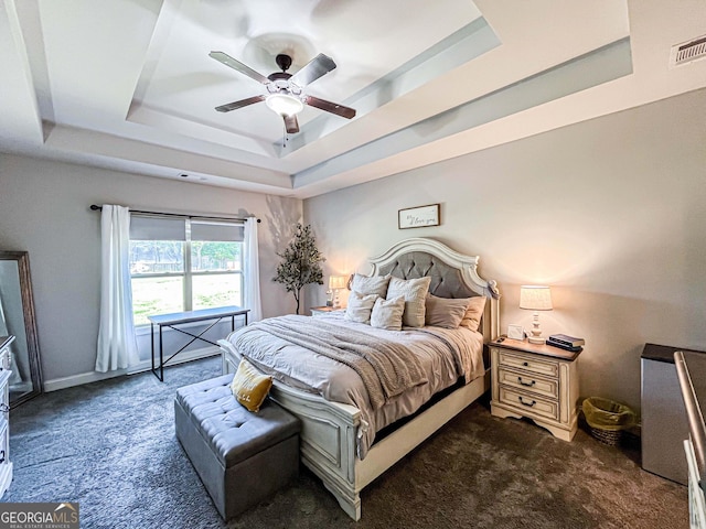 125 Kayla Ct, Locust Grove, GA 30248 - bedroom with a tray ceiling, dark carpet, and ceiling fan