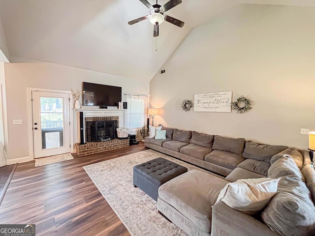 125 Kayla Ct, Locust Grove, GA 30248 - living area featuring a ceiling fan, dark wood-style flooring, high vaulted ceiling, a fireplace, and baseboards