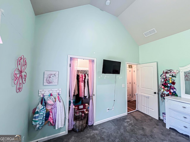 125 Kayla Ct, Locust Grove, GA 30248 - bedroom with high vaulted ceiling, dark colored carpet, and baseboards