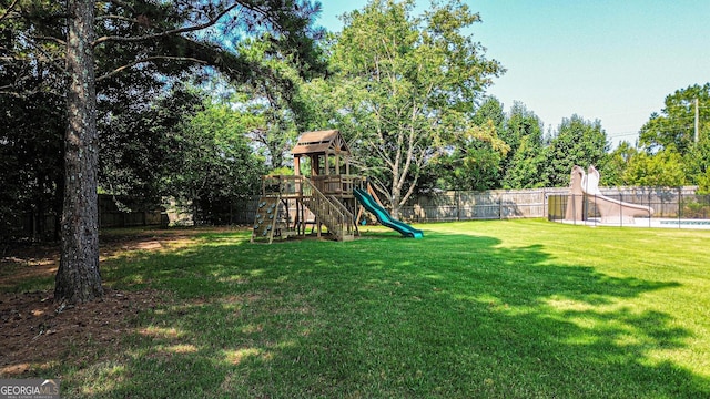 125 Kayla Ct, Locust Grove, GA 30248 - view of yard featuring a playground and view of wooded area