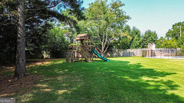 125 Kayla Ct, Locust Grove, GA 30248 - view of yard featuring a playground and view of wooded area
