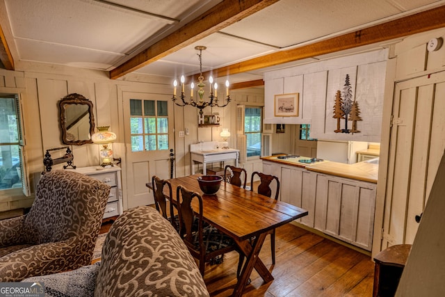 196 Elm St, Menlo, GA 30731 - dining space featuring dark wood finished floors, healthy amount of natural light, a chandelier, beam ceiling, and wood walls