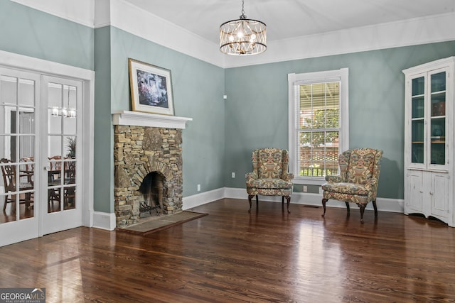 3119 Conyers St SE, Covington, GA 30014 - sitting room featuring a chandelier, wood finished floors, ornamental molding, baseboards, and a stone fireplace