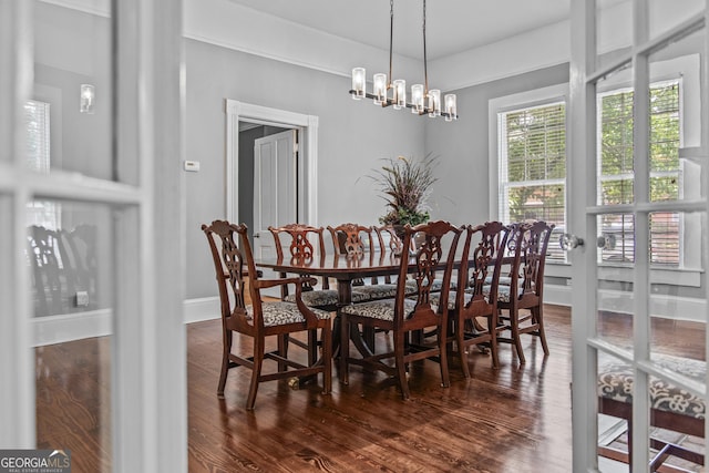 3119 Conyers St SE, Covington, GA 30014 - dining space with dark wood-style flooring, a chandelier, and baseboards