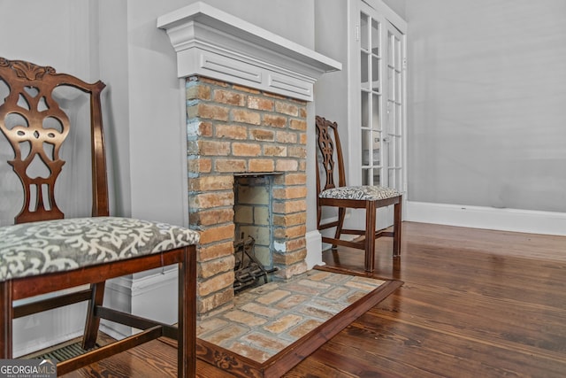 3119 Conyers St SE, Covington, GA 30014 - detailed view of baseboards, wood finished floors, and a brick fireplace