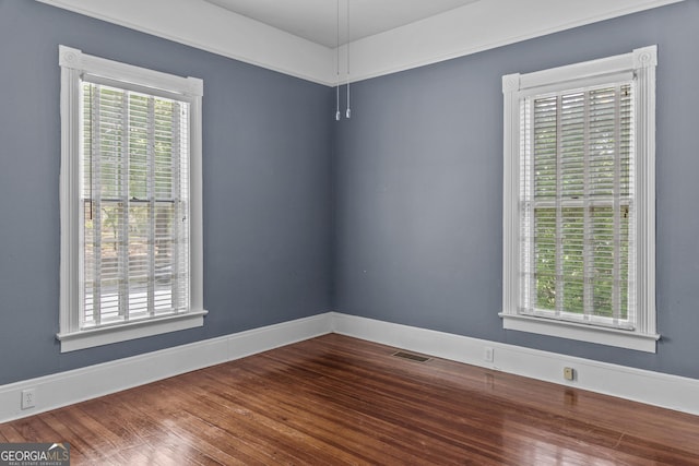 3119 Conyers St SE, Covington, GA 30014 - spare room with healthy amount of natural light, wood finished floors, and baseboards