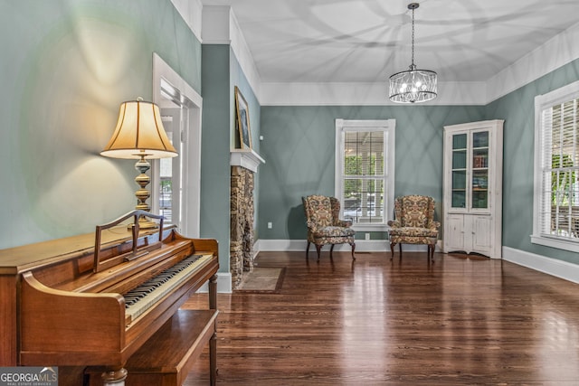 3119 Conyers St SE, Covington, GA 30014 - sitting room with wood finished floors, a chandelier, and baseboards