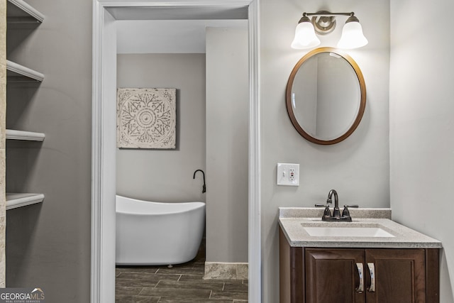 3119 Conyers St SE, Covington, GA 30014 - bathroom featuring a soaking tub, vanity, and wood tiled floors