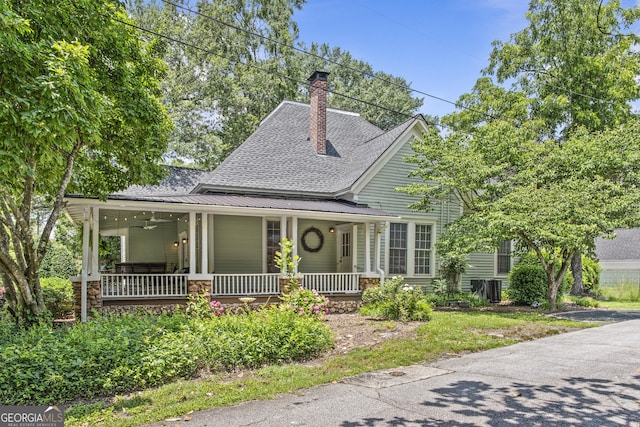 3119 Conyers St SE, Covington, GA 30014 - view of front of house featuring a porch, a shingled roof, and a chimney