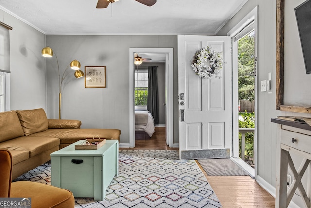 3119 Conyers St SE, Covington, GA 30014 - living area featuring a ceiling fan, light wood-style flooring, crown molding, and baseboards