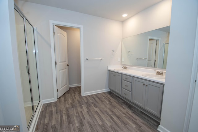 26 Sepia Oak Dr, Newnan, GA 30263 - full bath with wood finished floors, double vanity, a stall shower, and baseboards
