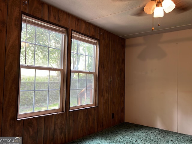 218 Helen Rd, Covington, GA 30016 - carpeted spare room with wood walls and ceiling fan