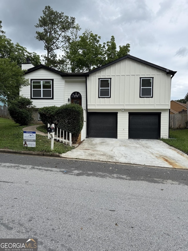 1340 Stoneleigh Way, Stone Mountain, GA 30088 - view of front facade with a garage, board and batten siding, and driveway