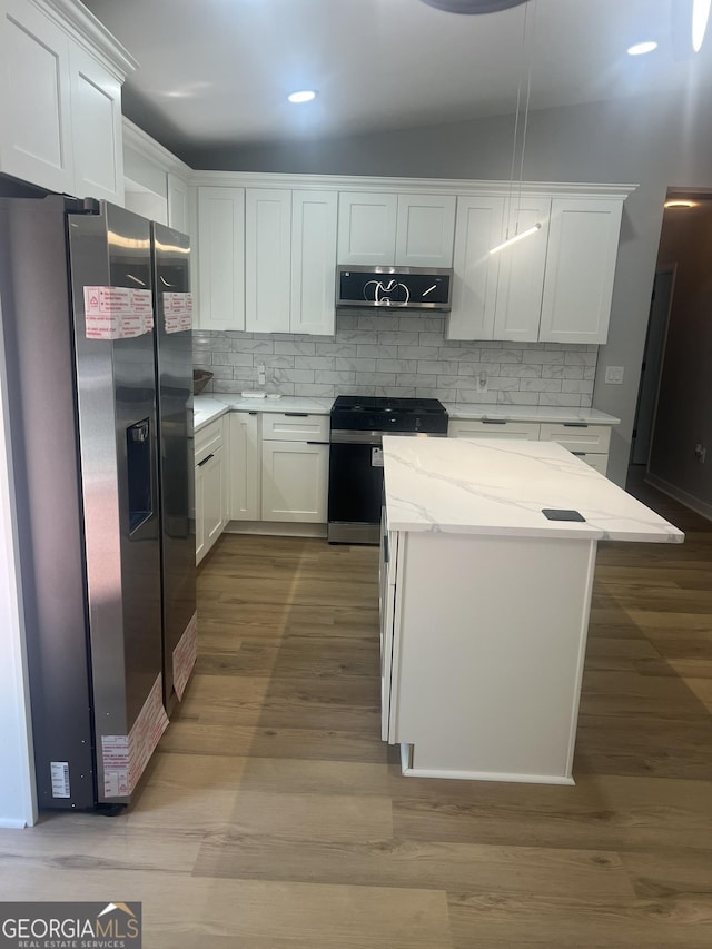 1340 Stoneleigh Way, Stone Mountain, GA 30088 - kitchen featuring stainless steel fridge, range with gas stovetop, ventilation hood, white cabinets, and recessed lighting