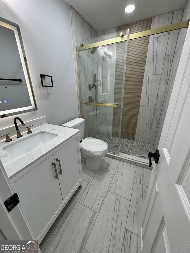 1340 Stoneleigh Way, Stone Mountain, GA 30088 - bathroom featuring vanity, a stall shower, and recessed lighting