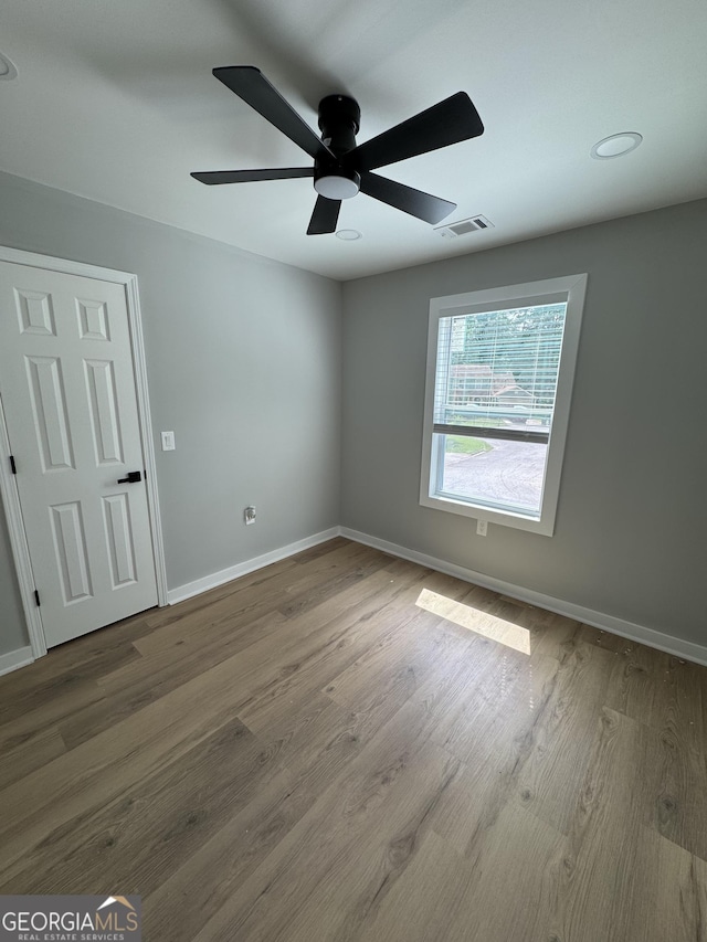 1340 Stoneleigh Way, Stone Mountain, GA 30088 - spare room featuring ceiling fan and wood finished floors