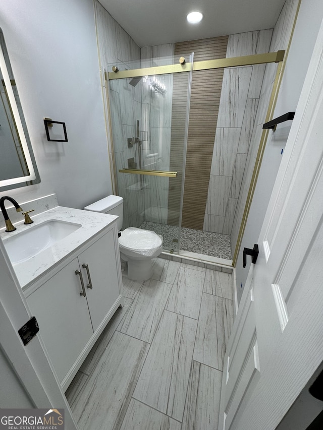1340 Stoneleigh Way, Stone Mountain, GA 30088 - bathroom featuring vanity, a stall shower, and recessed lighting