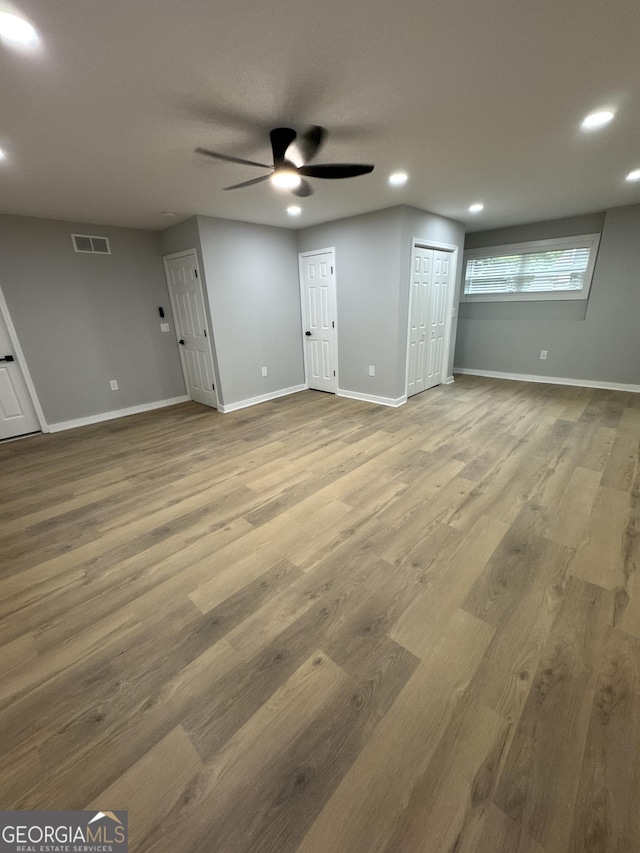 1340 Stoneleigh Way, Stone Mountain, GA 30088 - unfurnished living room featuring a ceiling fan, recessed lighting, and wood finished floors