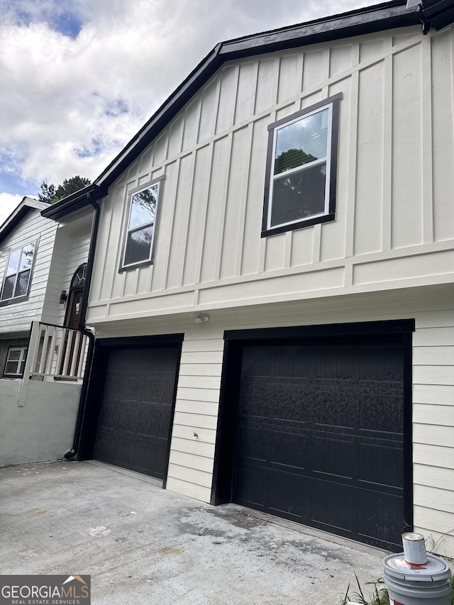 1340 Stoneleigh Way, Stone Mountain, GA 30088 - view of side of home with an attached garage and board and batten siding