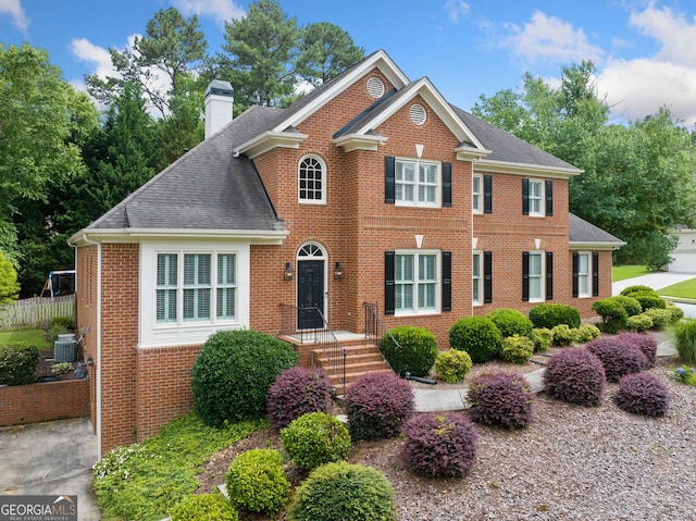 1360 Wilmington Way, Grayson, GA 30017 - view of front facade featuring central AC, brick siding, roof with shingles, and a chimney