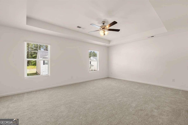 11884 Aukerman Way, Hampton, GA 30228 - spare room featuring a tray ceiling, baseboards, light colored carpet, and a ceiling fan