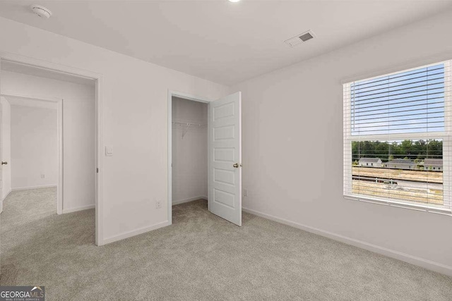 11884 Aukerman Way, Hampton, GA 30228 - unfurnished bedroom with light carpet, baseboards, and a closet