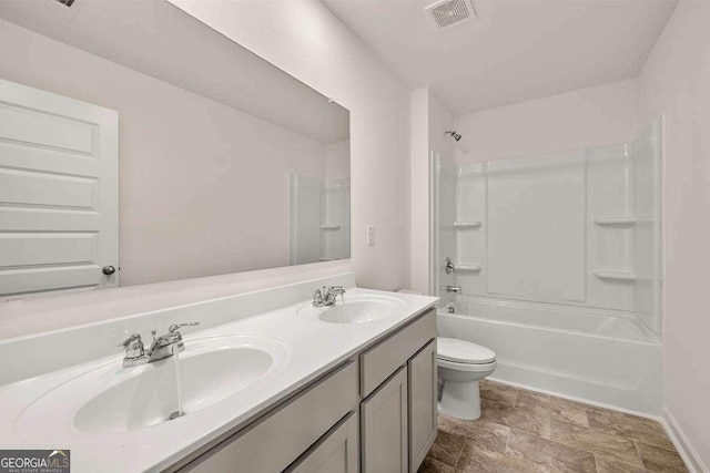 11884 Aukerman Way, Hampton, GA 30228 - full bathroom with toilet, double vanity,  shower combination, stone finish flooring, and baseboards