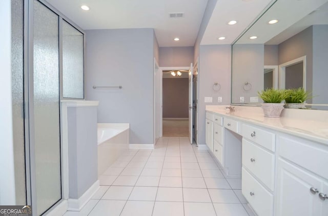 1570 Woodberry Run Dr, Snellville, GA 30078 - bathroom featuring a garden tub, double vanity, a stall shower, recessed lighting, and tile patterned flooring
