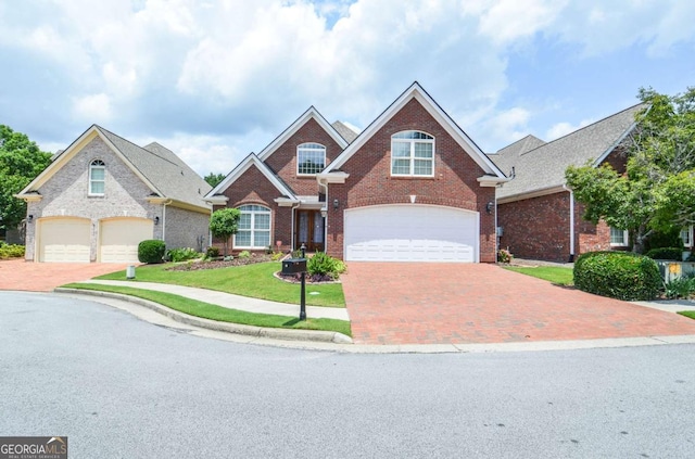 1570 Woodberry Run Dr, Snellville, GA 30078 - traditional-style house featuring brick siding, decorative driveway, an attached garage, and a front lawn