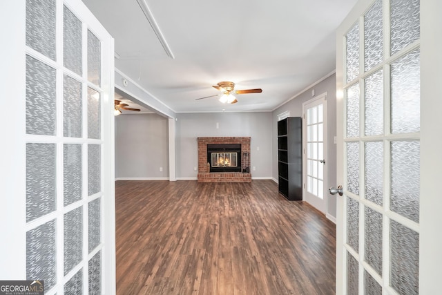 172B Hummingbird Ln, Jackson, GA 30233 - unfurnished living room featuring a ceiling fan, dark wood finished floors, ornamental molding, attic access, and a fireplace
