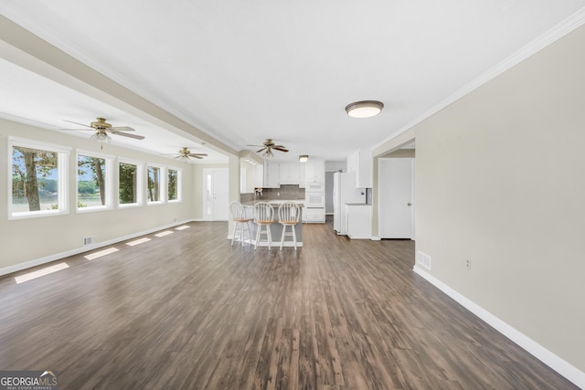 172B Hummingbird Ln, Jackson, GA 30233 - living room featuring dark wood-style floors, a ceiling fan, and ornamental molding