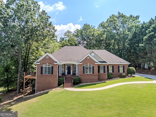 31 Bluff Mountain Dr SW, Rome, GA 30165 - view of front of home featuring brick siding, a front lawn, and a wooden deck