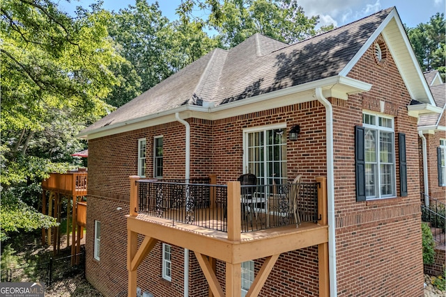 31 Bluff Mountain Dr SW, Rome, GA 30165 - view of home's exterior featuring brick siding, a shingled roof, and a deck