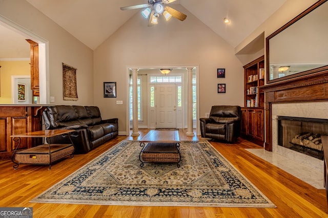 31 Bluff Mountain Dr SW, Rome, GA 30165 - living room featuring high vaulted ceiling, wood finished floors, ceiling fan, ornate columns, and a fireplace