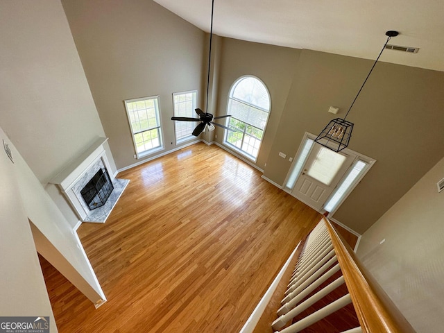 2355 Brick Mill Ct, Duluth, GA 30096 - unfurnished living room featuring high vaulted ceiling, light wood-style floors, a fireplace, and a ceiling fan
