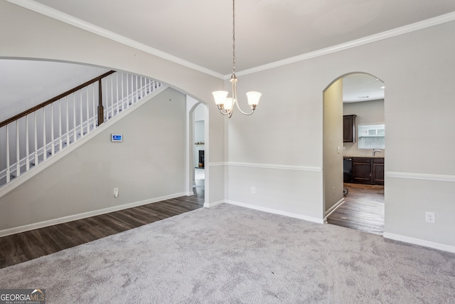 98 Concord Pl, Hiram, GA 30141 - spare room featuring carpet flooring, arched walkways, ornamental molding, stairs, and a chandelier