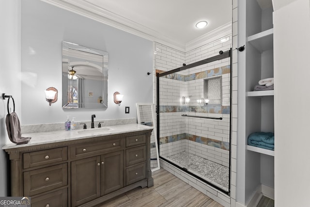 209 Athens St, Jefferson, GA 30549 - full bathroom with crown molding, a shower stall, vanity, ceiling fan, and wood finished floors