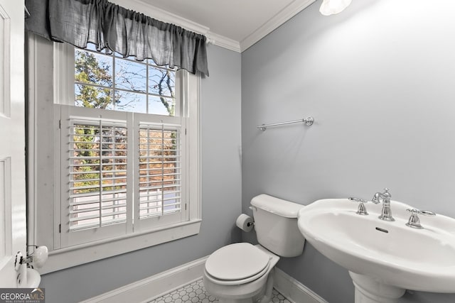 209 Athens St, Jefferson, GA 30549 - half bathroom with ornamental molding, toilet, baseboards, a sink, and tile patterned flooring