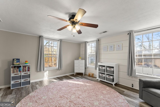 209 Athens St, Jefferson, GA 30549 - bedroom featuring a textured ceiling, multiple windows, wood finished floors, and a ceiling fan