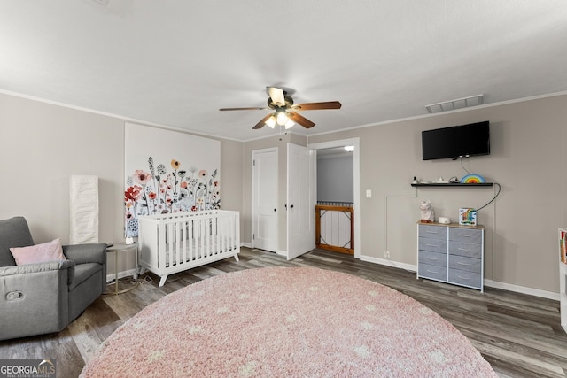 209 Athens St, Jefferson, GA 30549 - bedroom with wood finished floors, baseboards, ornamental molding, a ceiling fan, and a crib