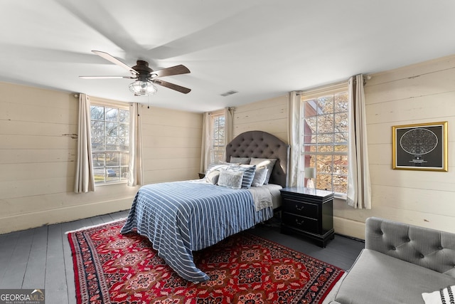 209 Athens St, Jefferson, GA 30549 - bedroom featuring wooden walls, hardwood / wood-style flooring, and ceiling fan