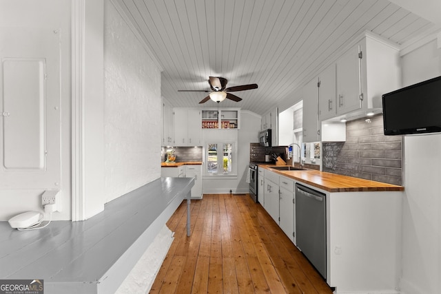 209 Athens St, Jefferson, GA 30549 - kitchen featuring appliances with stainless steel finishes, a sink, wood ceiling, electric panel, and white cabinets