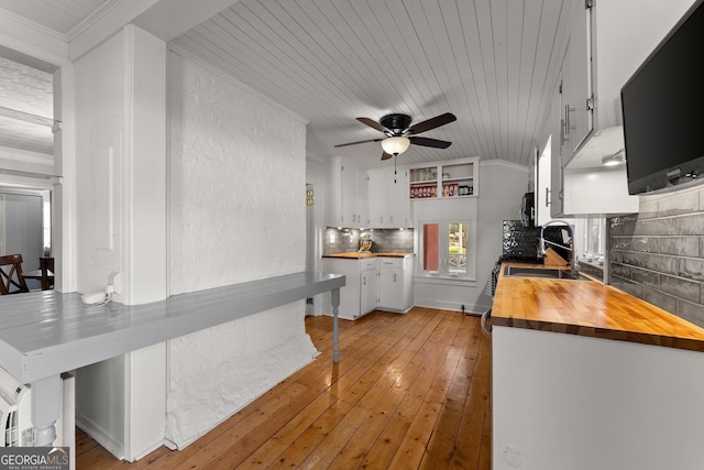 209 Athens St, Jefferson, GA 30549 - kitchen with butcher block counters, a ceiling fan, white cabinetry, decorative backsplash, and light wood-type flooring