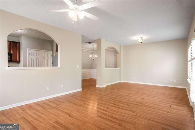 11151 Aliyah Dr, Hampton, GA 30228 - empty room with light wood finished floors, a ceiling fan, and arched walkways
