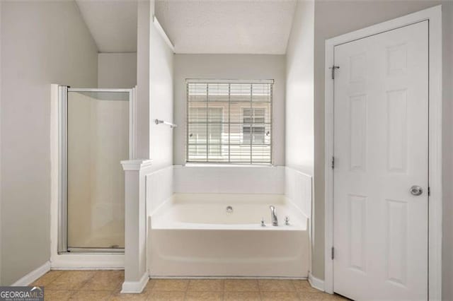 11151 Aliyah Dr, Hampton, GA 30228 - full bath with a stall shower, a bath, tile patterned floors, and a textured ceiling