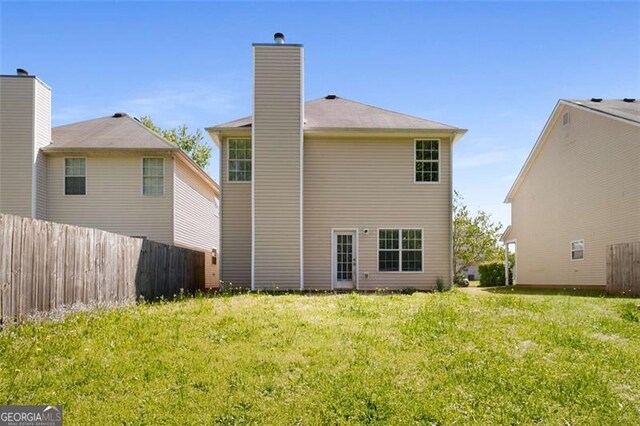 11151 Aliyah Dr, Hampton, GA 30228 - back of house with a chimney