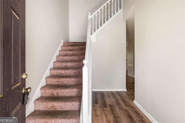 11151 Aliyah Dr, Hampton, GA 30228 - staircase with wood finished floors and baseboards