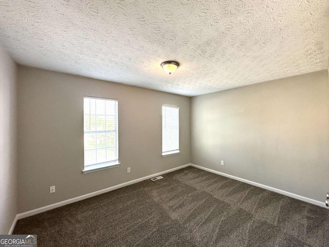 4320 Catalpa Way, Ellenwood, GA 30294 - unfurnished room with dark colored carpet, baseboards, and a textured ceiling