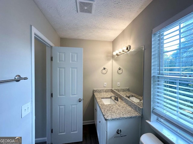 4320 Catalpa Way, Ellenwood, GA 30294 - bathroom featuring vanity, a textured ceiling, toilet, and wood finished floors