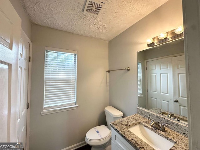 4320 Catalpa Way, Ellenwood, GA 30294 - bathroom with vanity, toilet, and a textured ceiling